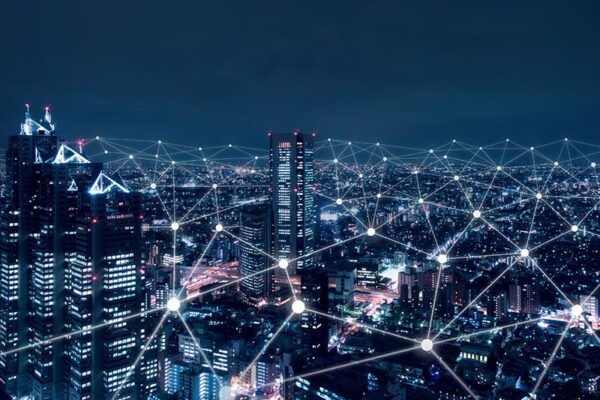 Connected digital lines superimposed over a city at night, representing eRedCap connectivity.