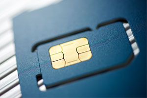Close-up of a SIM card, showing its gold contact chip embedded in a blue plastic card.