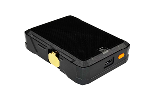 A black, rectangular electronic device with a textured surface, side button, gold clip, and a visible USB port.