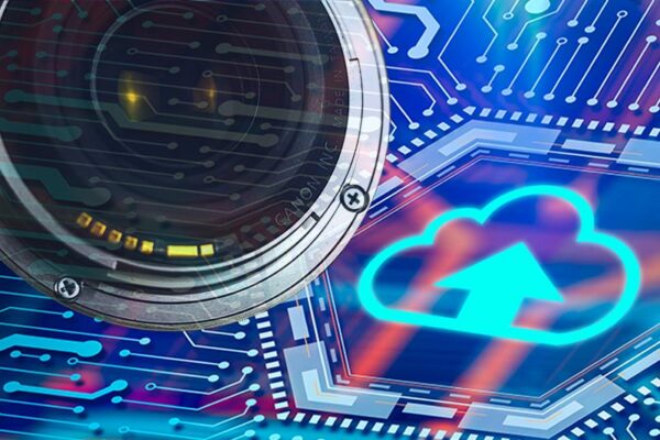 Close-up of a camera lens overlaid on a digital background with a glowing cloud upload icon and circuit patterns, suggesting cloud-based video storage or surveillance technology.
